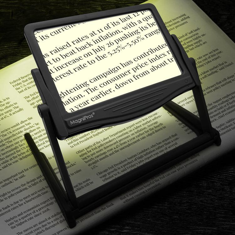 Magnifying glass with light on a book page, highlighting text.