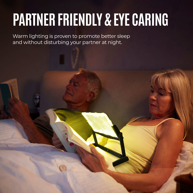 Two people in bed, one using a booklight to read, with text about partner-friendly and eye-care lighting.