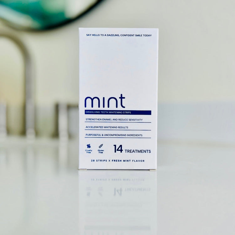 Box of Mint teeth whitening strips on a blurred bathroom counter background