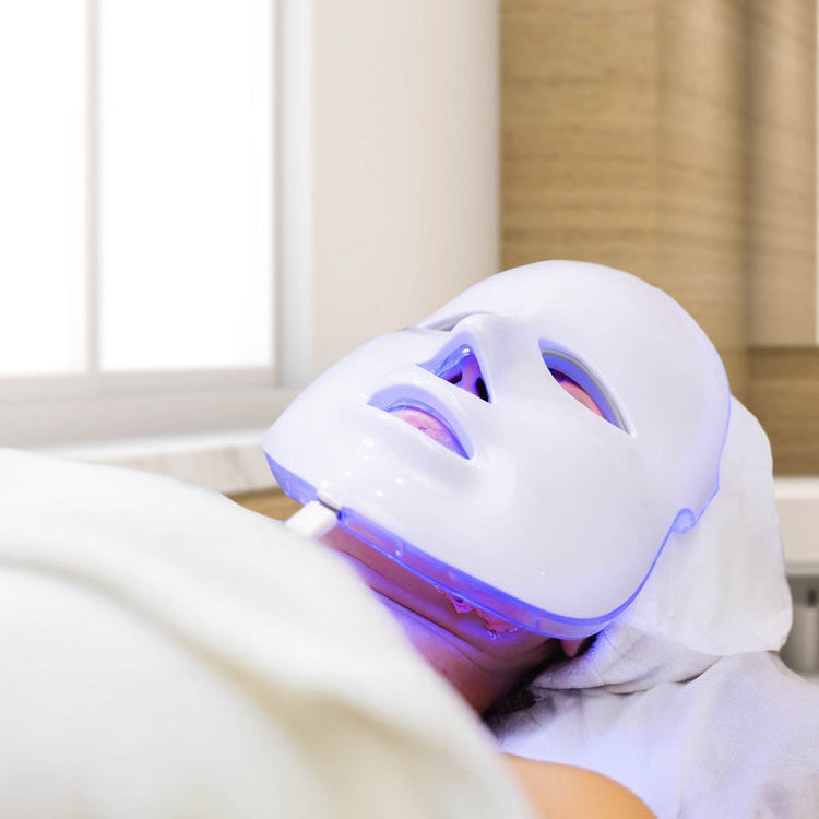 Person wearing a LED face mask in a clinical setting