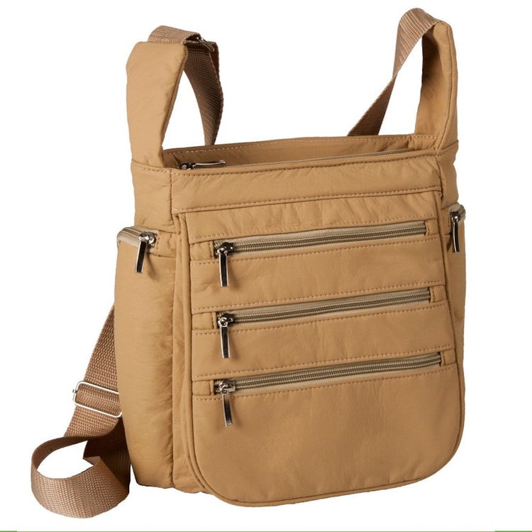 Tan crossbody bag with multiple pockets on a white background