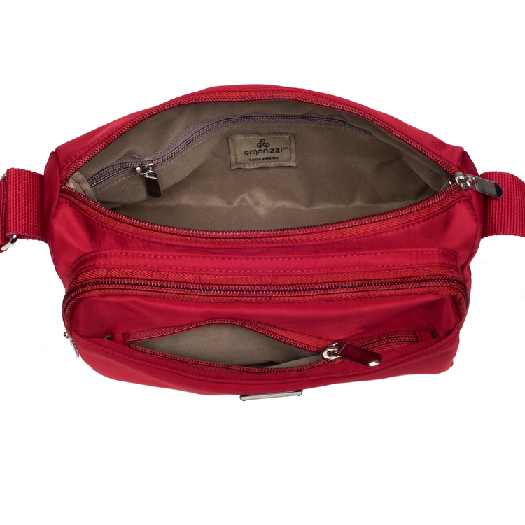 Red waist bag with multiple zippers on a white background