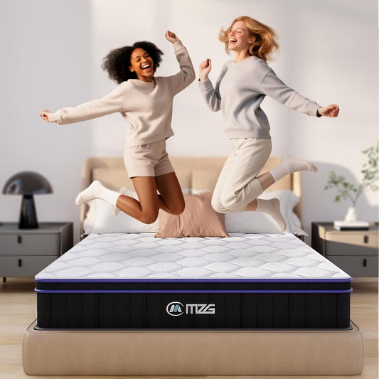 Two women jumping on a mattress in a room with furniture and decor.