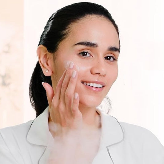 A LED light therapy facial mask and a bottle of high energy hyaluronic serum, both branded by Pure Daily Care, with the mask illustrated in a rainbow of light colors and the serum bottle labeled.