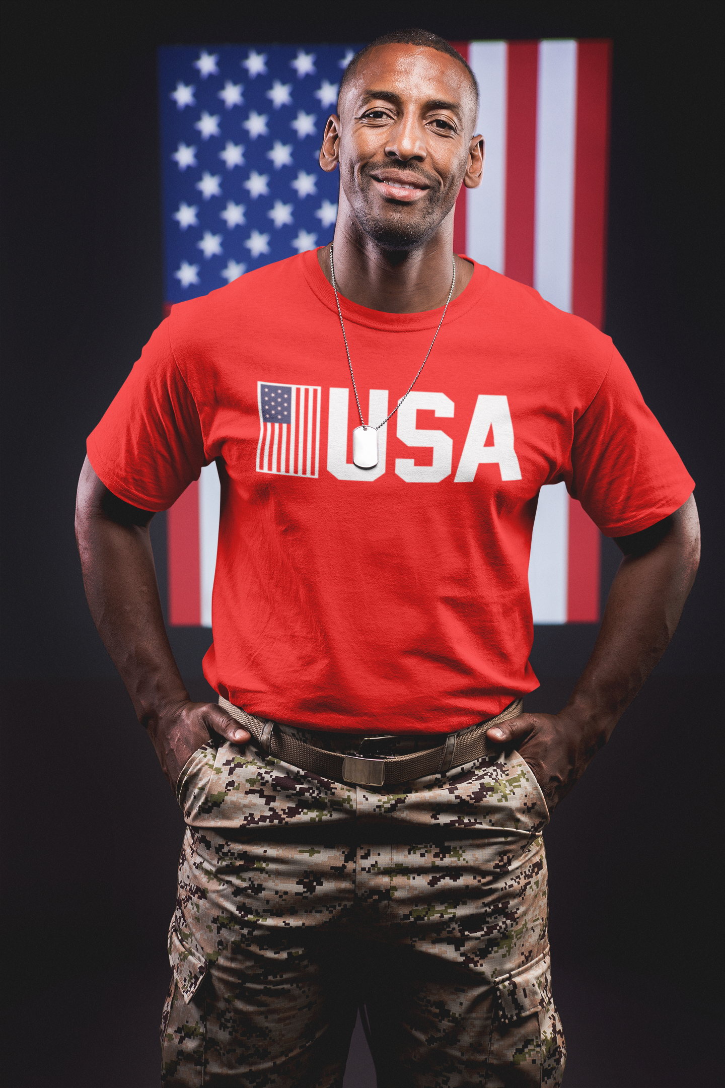 Person wearing a red 'USA' t-shirt with camouflage pants in front of an American flag.