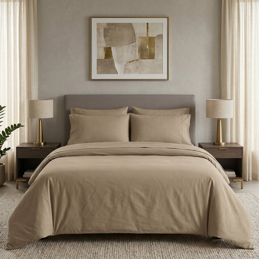 Neatly made bed with white bedding and pillows in a room with wooden nightstands and lamps.
