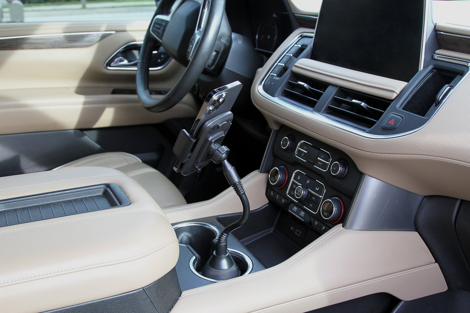 Car interior with beige seats, steering wheel, and dashboard.