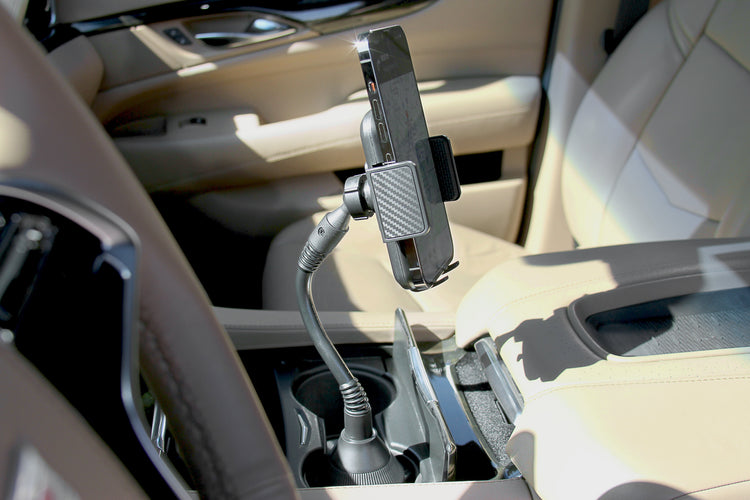 Car interior with a phone holder mounted on the dashboard.
