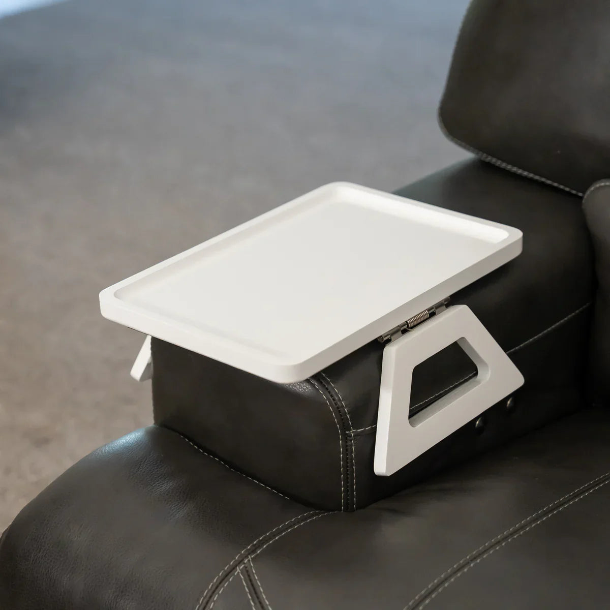 White lap desk on a black leather chair