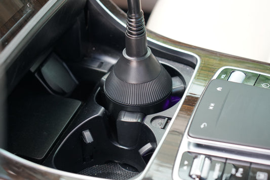 Black phone holder with cup holder on a white background