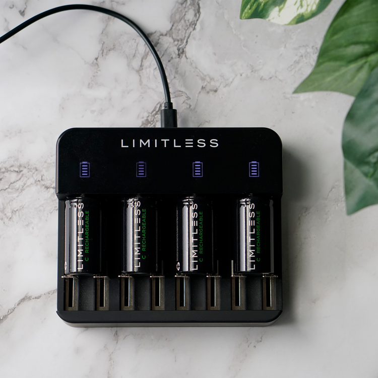 Limitless battery charger with four batteries on a marble surface