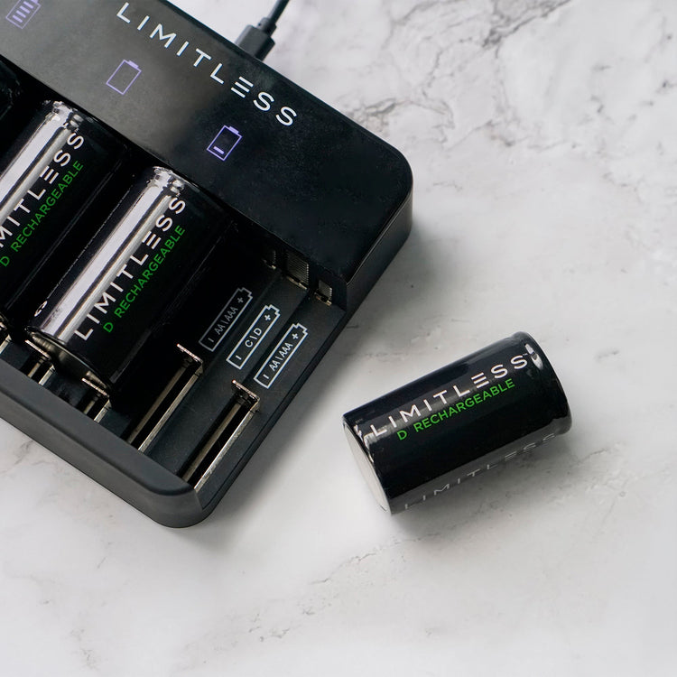 Limitless battery charger and rechargeable batteries on a marble surface