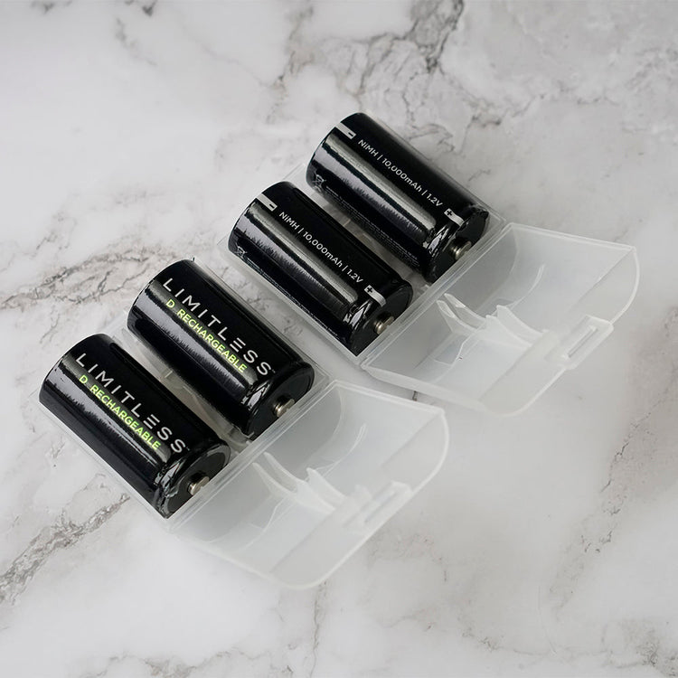 Black batteries with 'Limitless' branding in a clear plastic holder on a marble surface