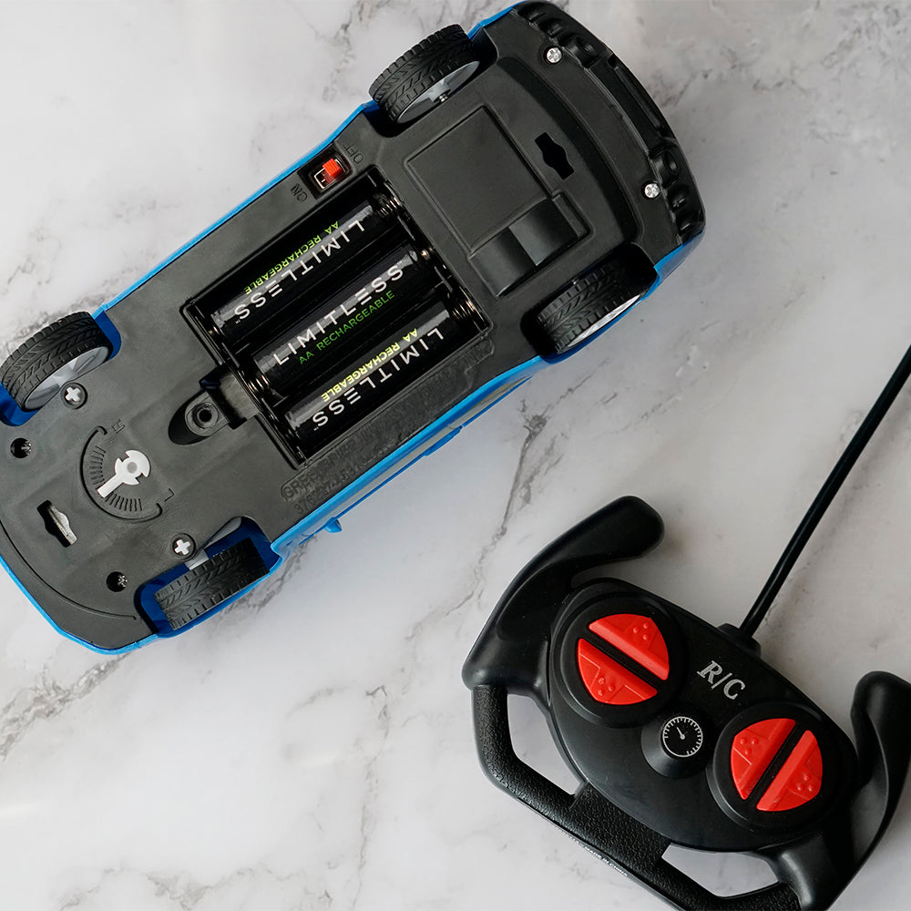 Close-up of a remote control car and its battery compartment on a marble surface