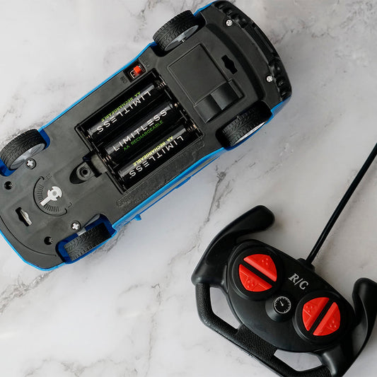 Black battery charger with multiple battery slots and Limitless branding, accompanied byLimitless batteries on a white background.