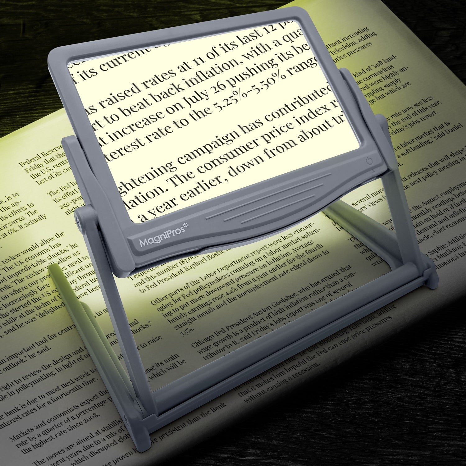 Magnifying glass with light on a book page, highlighting text.