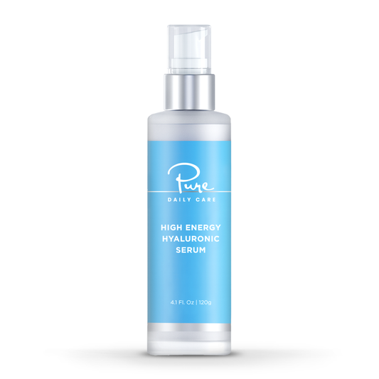 A LED light therapy facial mask and a bottle of high energy hyaluronic serum, both branded by Pure Daily Care, with the mask illustrated in a rainbow of light colors and the serum bottle labeled.