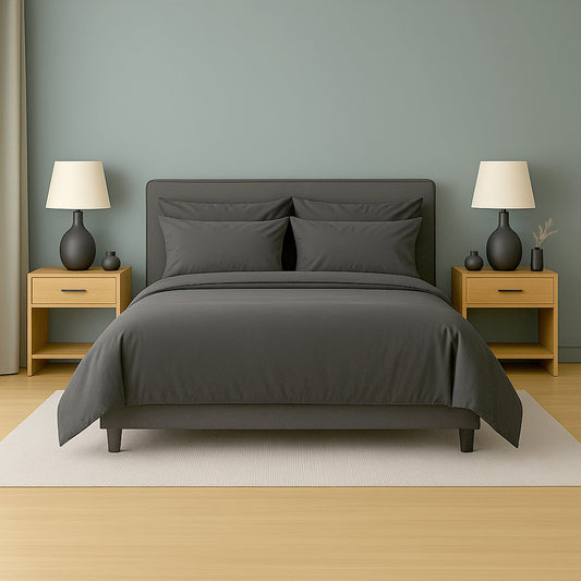 Dark-themed bedroom with black bedding, nightstands, and lamps.