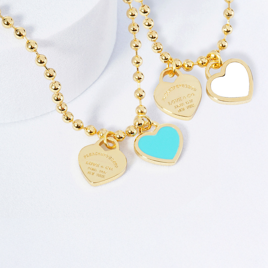 Two necklaces on mannequin busts with a blurred background