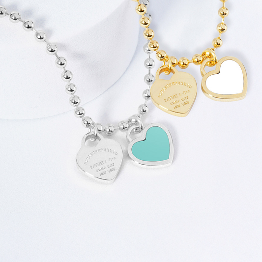 Two necklaces on mannequin busts with a blurred background