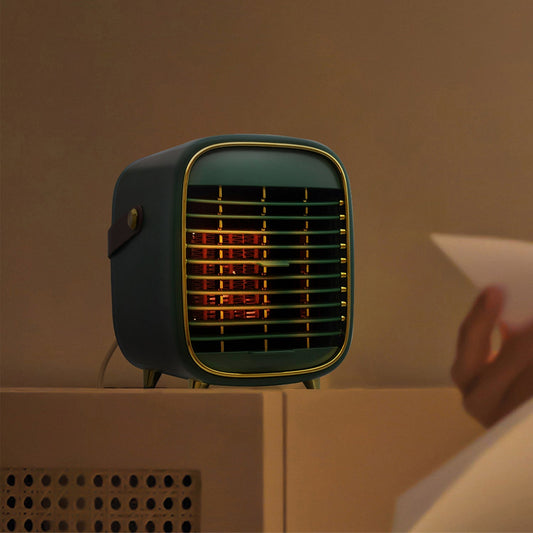 Small black heater on a beige surface with a warm glow