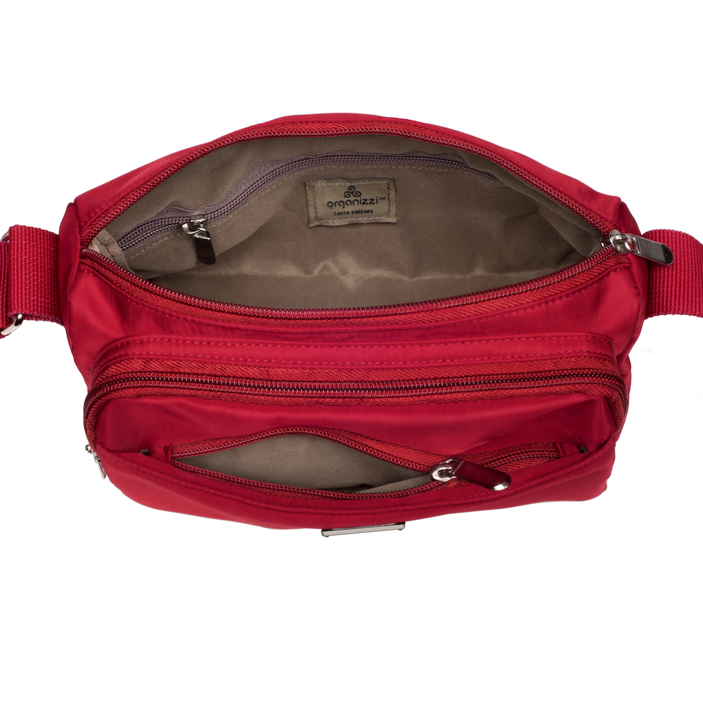 Red waist bag with multiple zippers on a white background
