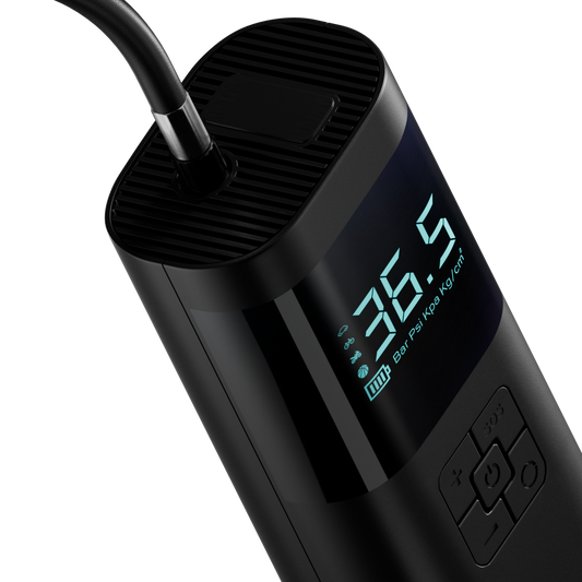 Black digital tire pressure monitor with digital display on a white background