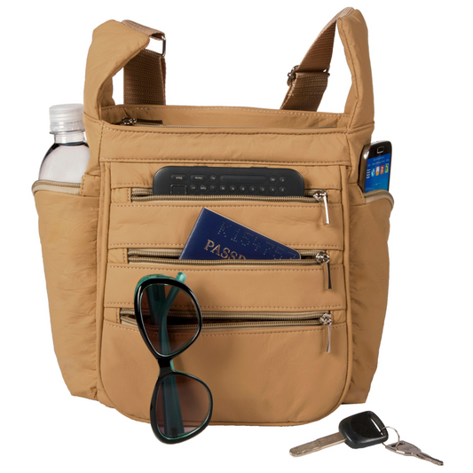 Tan crossbody bag with multiple pockets on a white background