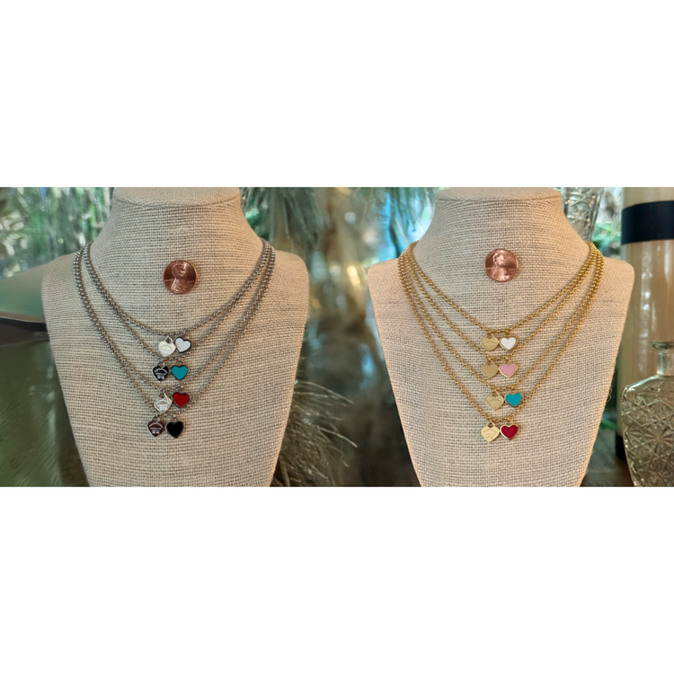 Two necklaces on mannequin busts with a blurred background