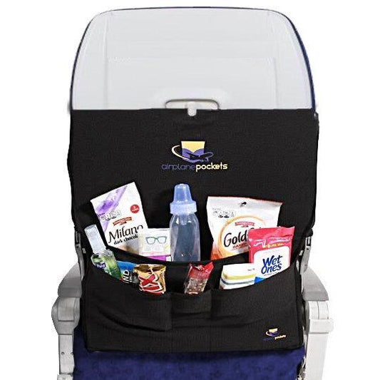 Airplane seat with 'airplane pockets' organizer holding a tablet, book, and drink.